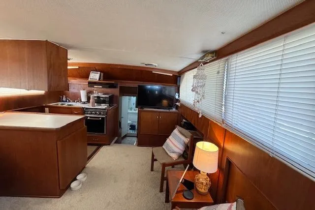 Slide: The Image of Interior of 1974 Chris-Craft 47 Commander yacht with cozy living area and kitchen. - 25