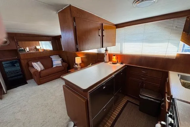 Slide: The Image of Interior of 1974 Chris-Craft 47 Commander yacht with cozy kitchen and seating area. - 28