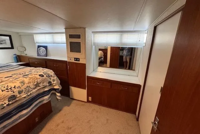 Slide: The Image of Interior of 1974 Chris-Craft 47 Commander yacht with wood cabinetry and cozy decor. - 35