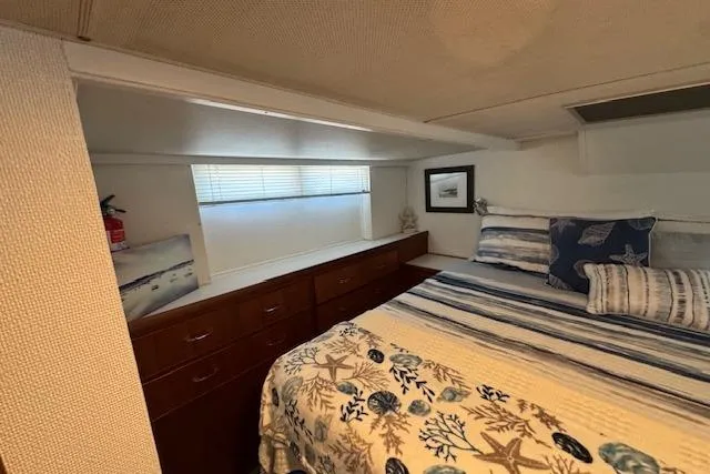 Slide: The Image of Cozy bedroom in 1974 Chris-Craft 47 Commander yacht with nautical-themed bedding. - 36
