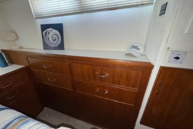 Slide: The Image of 1974 Chris-Craft 47 Commander interior with wooden cabinets and decorative elements. - 39