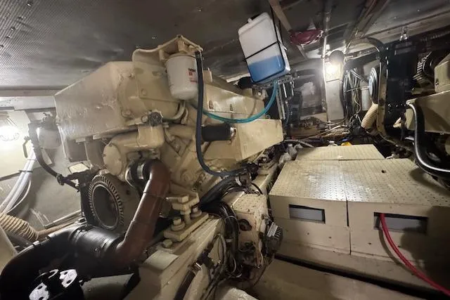 Slide: The Image of Engine room of a 1974 Chris-Craft 47 Commander yacht, showcasing mechanical components. - 48