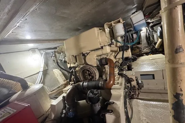 Slide: The Image of Engine room of a 1974 Chris-Craft 47 Commander, showcasing mechanical components and piping. - 50