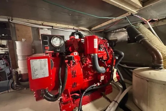 Slide: The Image of Engine room of 1974 Chris-Craft 47 Commander with red machinery and gauges. - 52