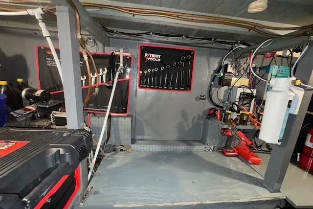 Slide: The Image of Engine room of 1974 Chris-Craft 47 Commander with tools and equipment neatly organized. - 55