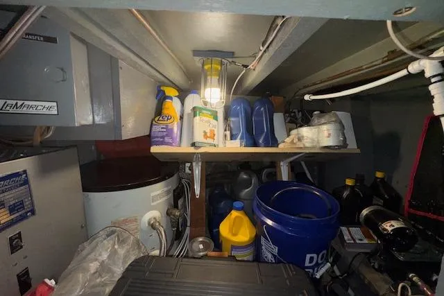 Slide: The Image of Storage area in a 1974 Chris-Craft 47 Commander with various cleaning supplies and equipment. - 57