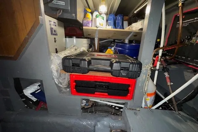 Slide: The Image of Storage area in a 1974 Chris-Craft 47 Commander boat with tools and cleaning supplies. - 58