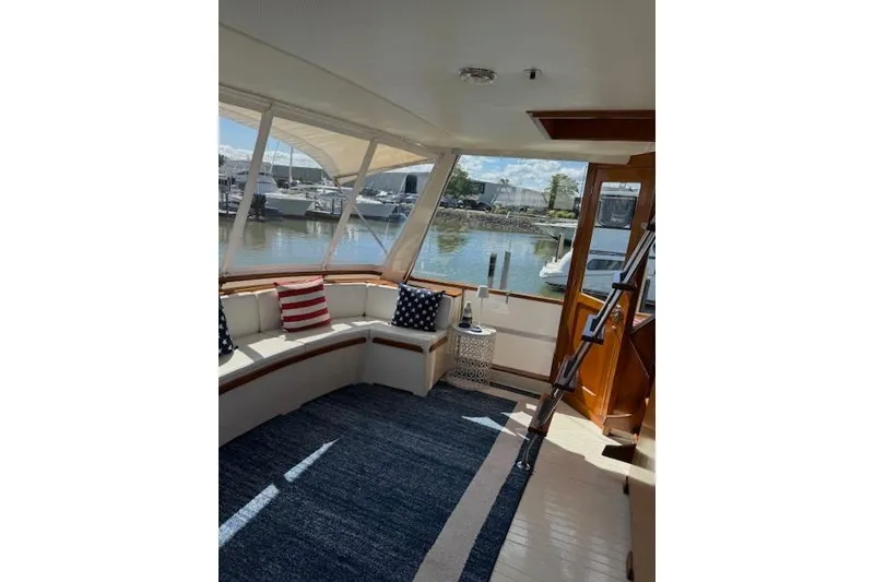 Slide: The Image of 1974 Chris-Craft 47 Commander interior with nautical decor and marina view. - 6