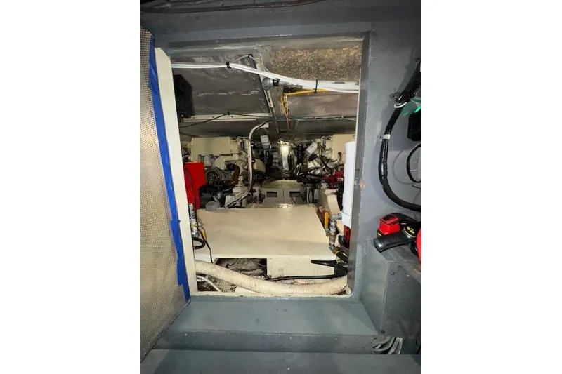 Slide: The Image of Engine room of 1974 Chris-Craft 47 Commander, showcasing mechanical components and wiring. - 60