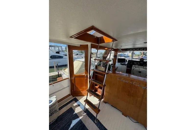 Slide: The Image of Interior of 1974 Chris-Craft 47 Commander yacht with wooden ladder and helm station. - 8