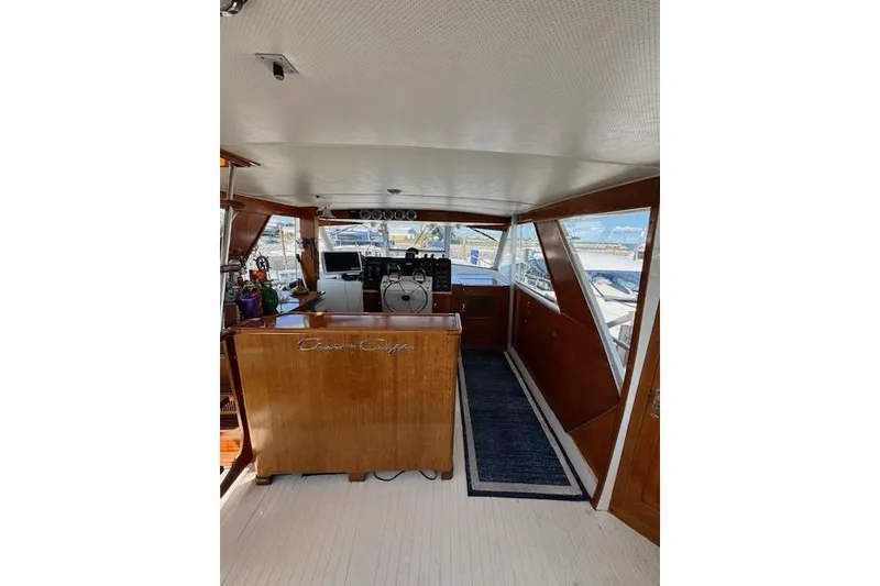 Slide: The Image of 1974 Chris-Craft 47 Commander interior with wooden finish and helm station. - 9