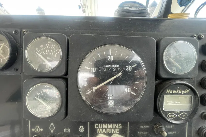 Slide: The Image of Instrument panel of a 1995 Albin 28 boat showing engine hours and gauges. - 15