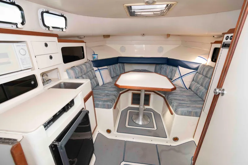 Slide: The Image of Interior of 1995 Albin 28 Tournament Express with dining area and kitchenette. - 17