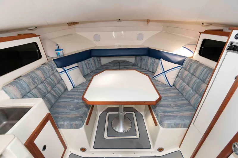 Slide: The Image of Interior of 1995 Albin 28 Tournament Express with cozy seating and table. - 18