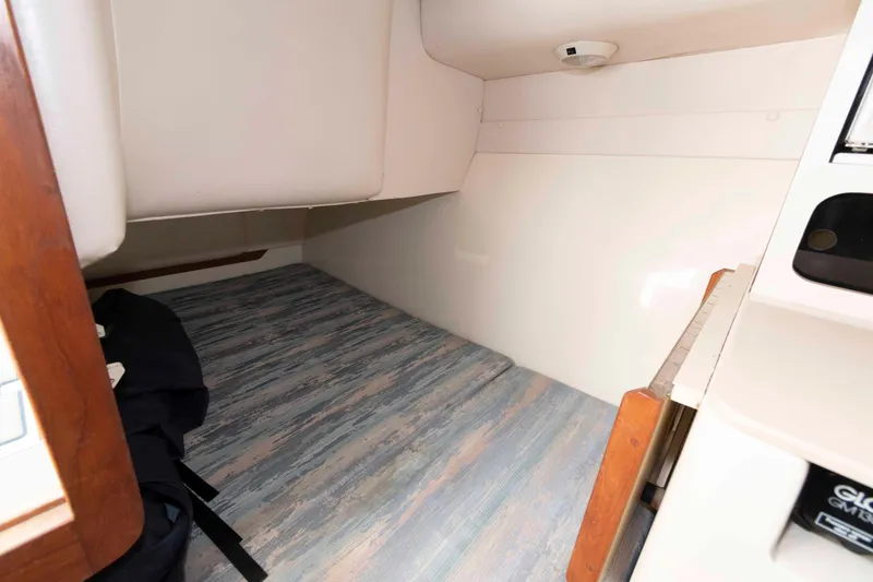 Slide: The Image of 1995 Albin 28 Tournament Express cabin interior with wood accents and patterned flooring. - 20