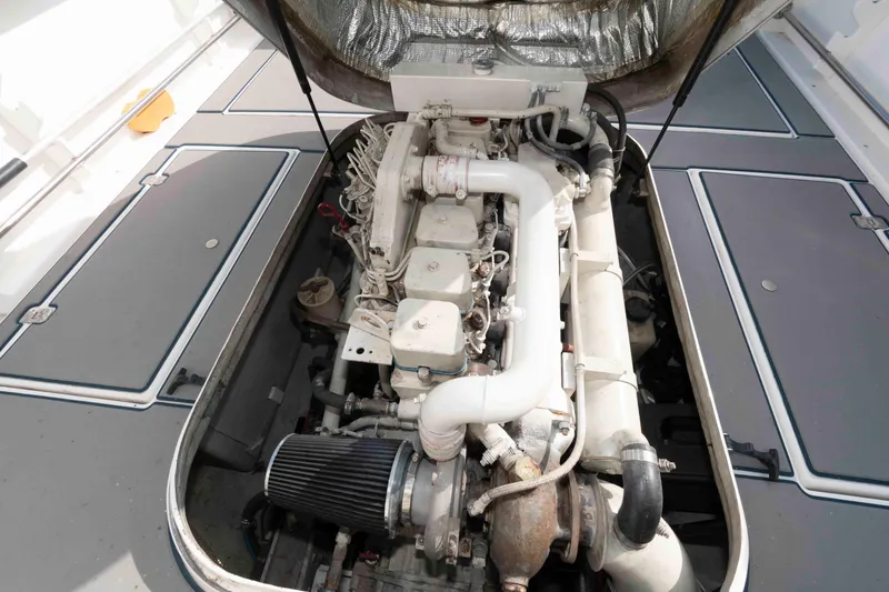Slide: The Image of Engine compartment of a 1995 Albin 28 Tournament Express boat, showcasing detailed components. - 22
