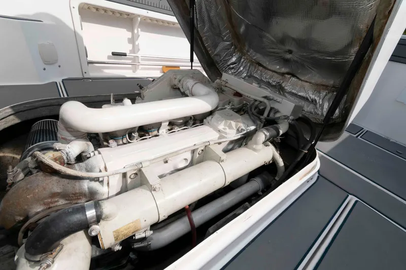 Slide: The Image of Engine compartment of a 1995 Albin 28 Tournament Express boat, showcasing mechanical components. - 23