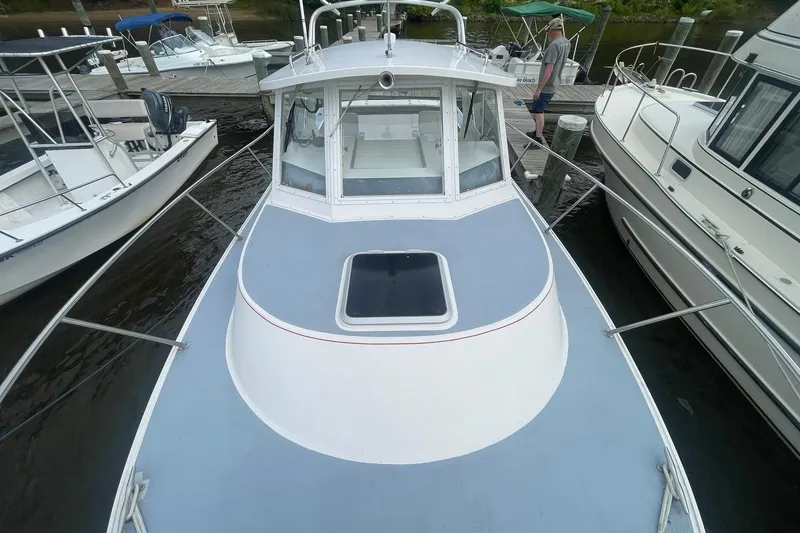 Slide: The Image of 1995 Albin 28 Tournament Express docked among other boats on a sunny day. - 7