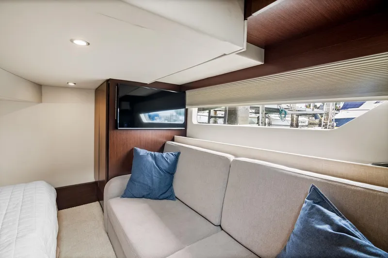 Slide: The Image of 2016 Regal 42 Grande Coupe yacht with spacious outdoor seating and wooden table. - 17