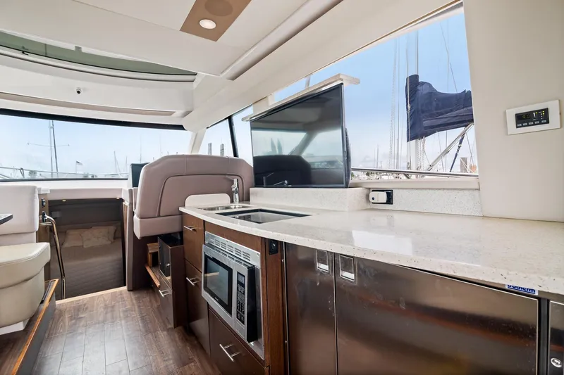 Slide: The Image of Helm of 2016 Regal 42 Grande Coupe with navigation display and controls. - 7