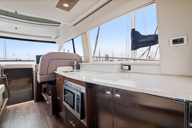 Slide: The Image of 2016 Regal 42 Grande Coupe helm with steering wheel and control panel. - 8