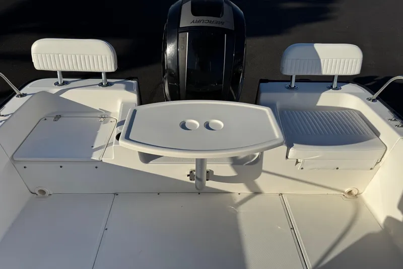 Slide: The Image of 2017 Boston Whaler 210 Montauk boat interior with seating and table. - 12