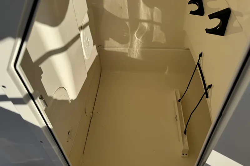 Slide: The Image of Storage compartment of a 2017 Boston Whaler 210 Montauk boat, featuring interior details. - 13