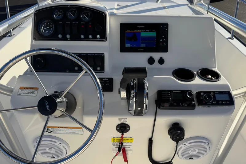 Slide: The Image of 2017 Boston Whaler 210 Montauk boat dashboard with steering wheel and navigation controls. - 14