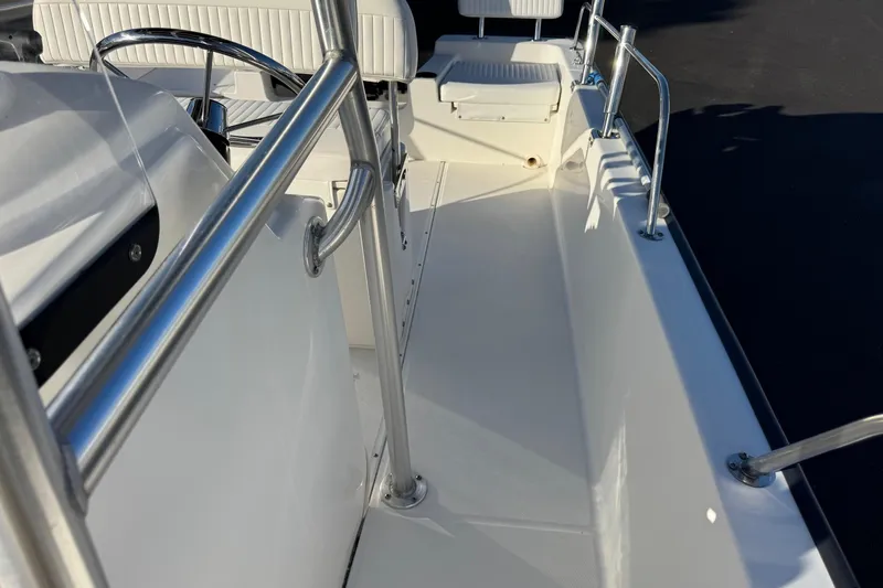 Slide: The Image of 2017 Boston Whaler 210 Montauk boat interior with stainless steel railings and seating. - 15