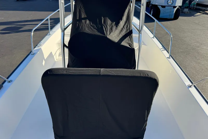 Slide: The Image of 2017 Boston Whaler 210 Montauk boat interior with black seat covers. - 17
