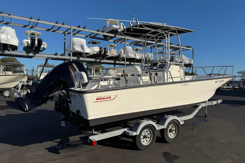 Slide: The Image of 2017 Boston Whaler 210 Montauk boat on trailer, parked in marina with other boats. - 4
