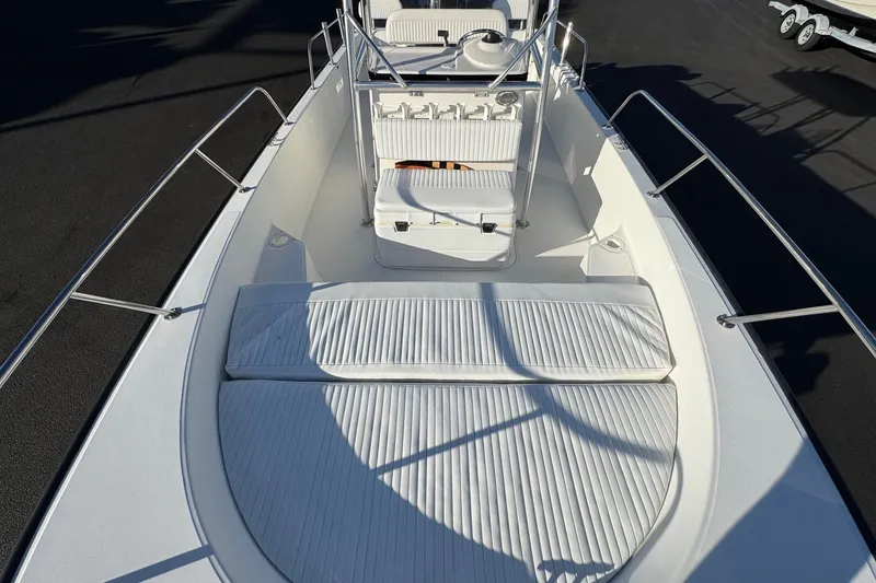 Slide: The Image of 2017 Boston Whaler 210 Montauk boat interior with white seating and railings. - 6