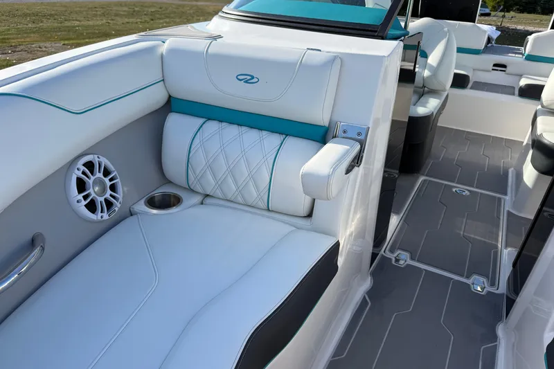 Slide: The Image of 2022 Regal LS2 boat interior with white seating, teal accents, and built-in speaker. - 13