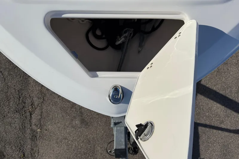 Slide: The Image of 2022 Regal LS2 boat anchor compartment with open hatch, showing interior details. - 14