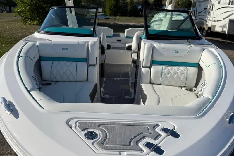 Slide: The Image of 2022 Regal LS2 boat interior with white and teal seating, open bow design. - 4