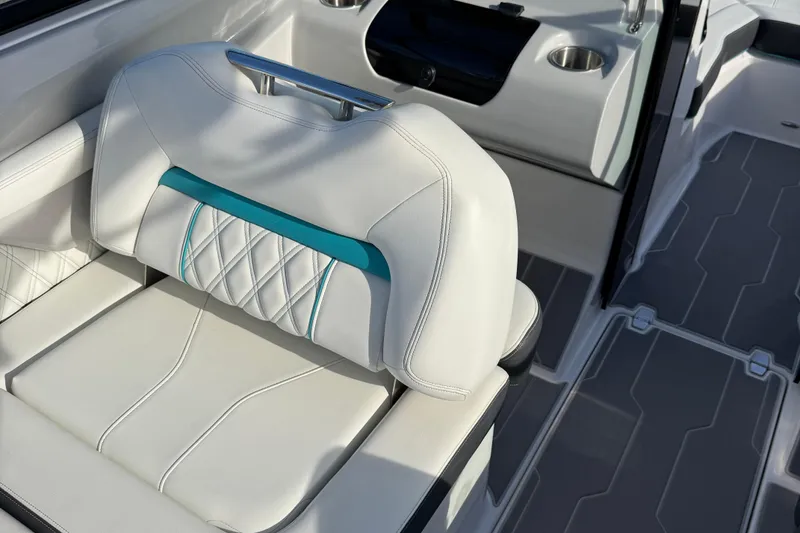 Slide: The Image of 2022 Regal LS2 boat interior with white and teal cushioned seating. - 8