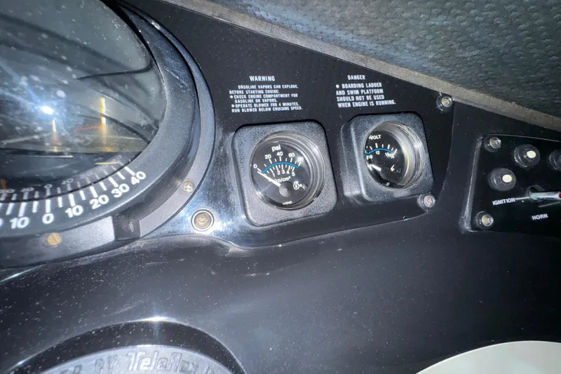 Slide: The Image of Dashboard of 1989 Glastron/Carlson 19 CSS boat with gauges and warning labels. - 14