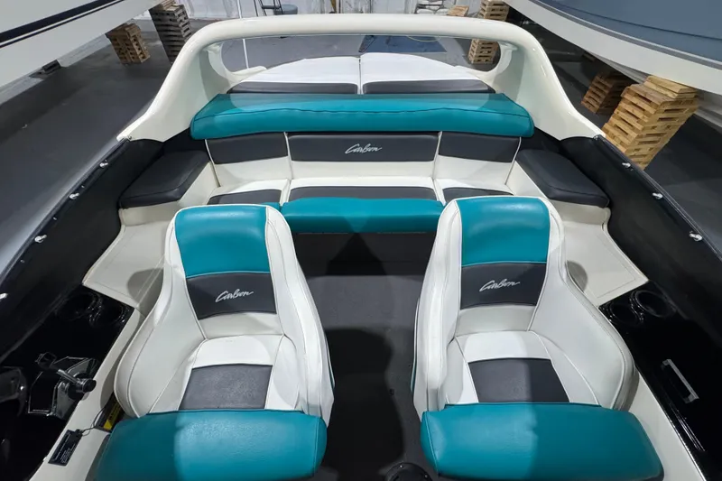 Slide: The Image of 1989 Glastron/Carlson 19 CSS boat interior with teal and white seating. - 7