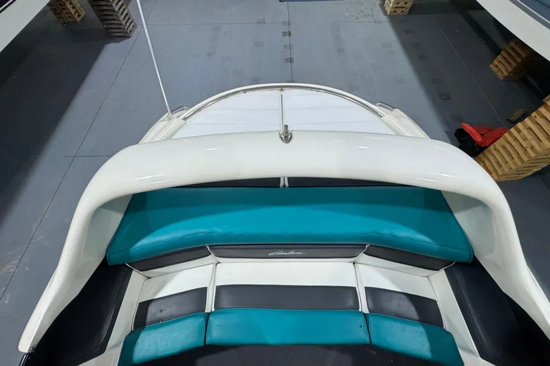 Slide: The Image of 1989 Glastron/Carlson 19 CSS boat interior with teal and white seating. - 8
