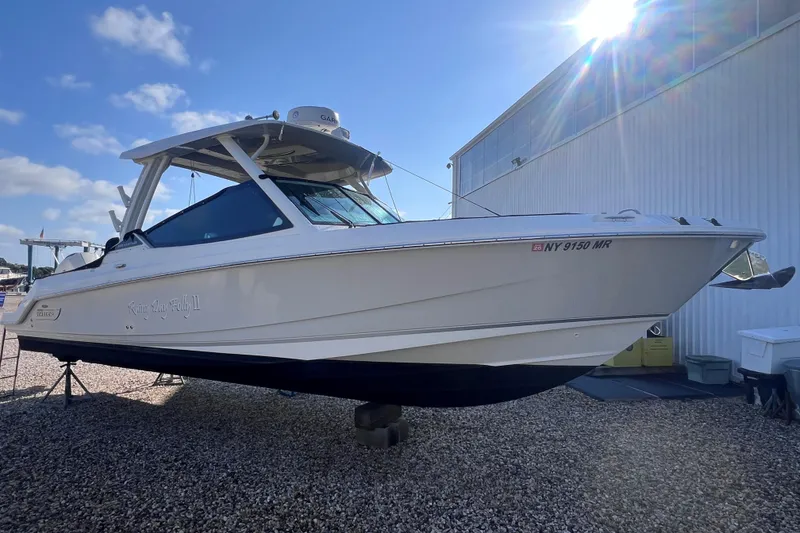 Slide: The Image of 2021 Boston Whaler 280 Vantage boat on display, sunny day, outdoor setting. - 1
