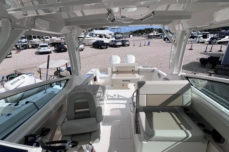 Slide: The Image of 2021 Boston Whaler 280 Vantage interior view at marina, showcasing seating and helm. - 12