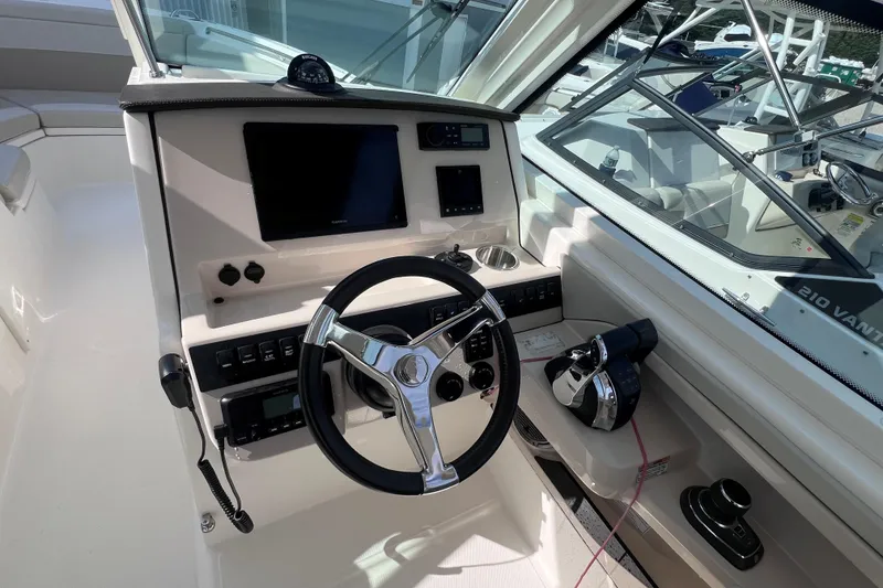 Slide: The Image of 2021 Boston Whaler 280 Vantage helm with steering wheel and navigation controls. - 14