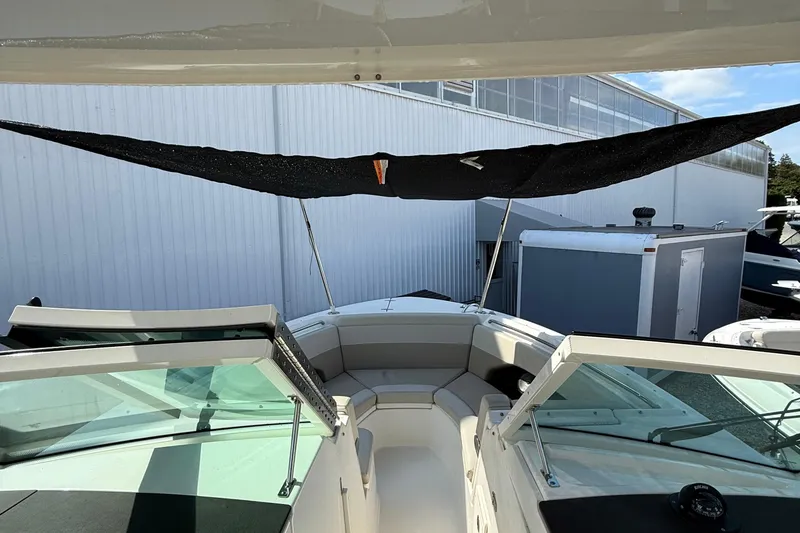 Slide: The Image of 2021 Boston Whaler 280 Vantage boat with sunshade, docked near a building. - 17