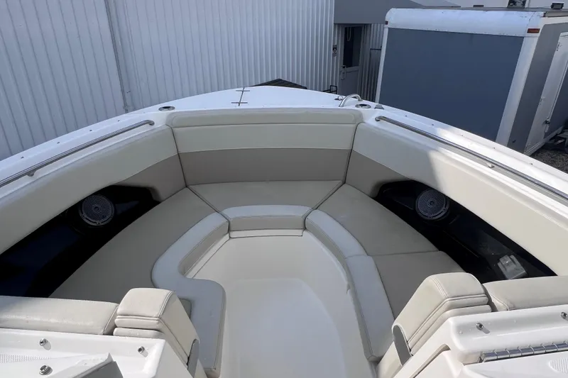 Slide: The Image of 2021 Boston Whaler 280 Vantage boat interior with cushioned seating and speakers. - 18