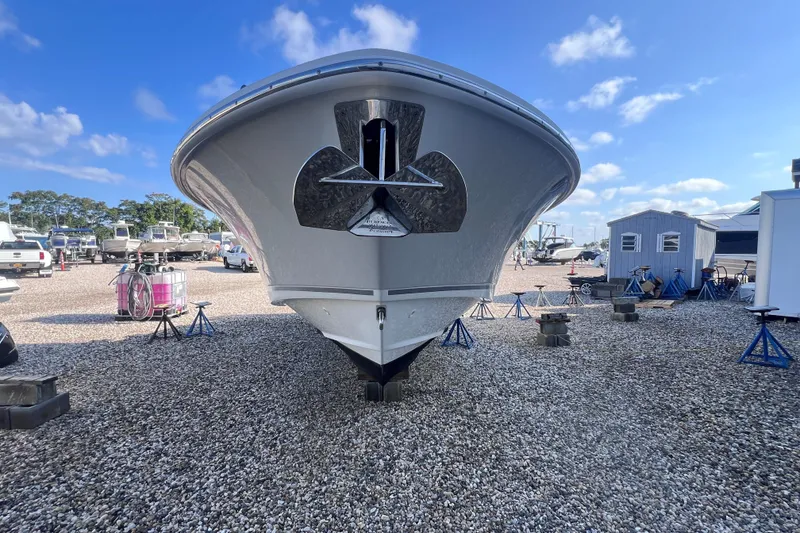 Slide: The Image of 2021 Boston Whaler 280 Vantage boat on gravel lot under blue sky. - 19