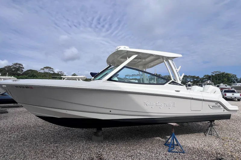 Slide: The Image of 2021 Boston Whaler 280 Vantage boat on display, side view, outdoors. - 23