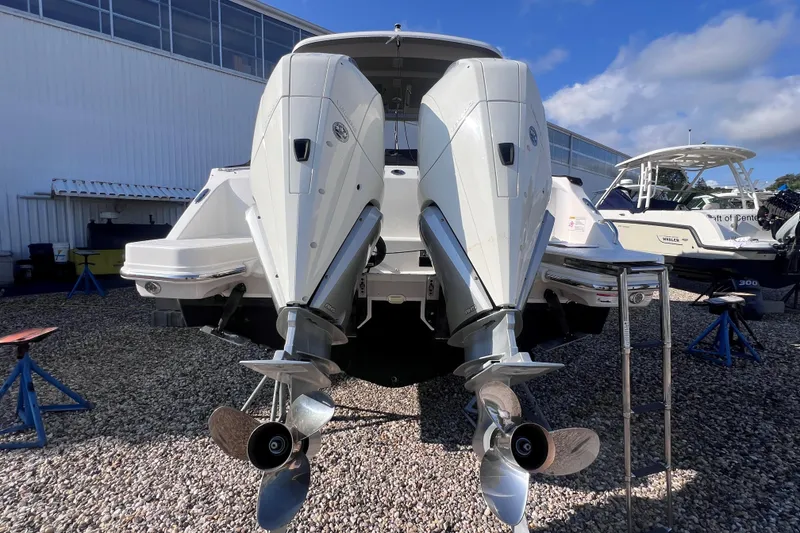 Slide: The Image of 2021 Boston Whaler 280 Vantage with dual outboard engines, displayed outdoors. - 4