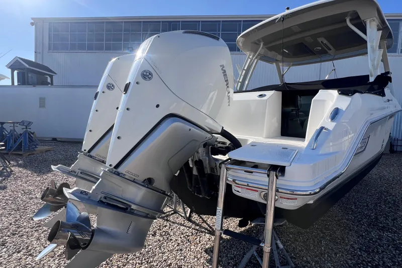 Slide: The Image of 2021 Boston Whaler 280 Vantage with dual Mercury outboard engines, docked outdoors. - 5