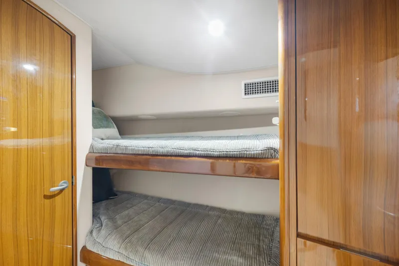 Slide: The Image of 2009 Viking 50 Convertible yacht interior with wooden bunk beds and modern design. - 26