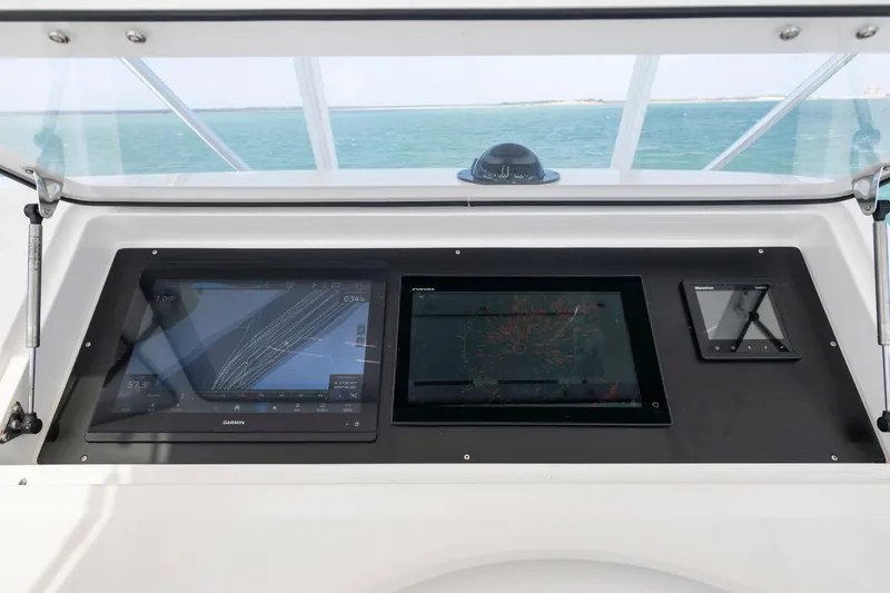 Slide: The Image of Control panel of a 2009 Viking 50 Convertible yacht with navigation displays. - 7